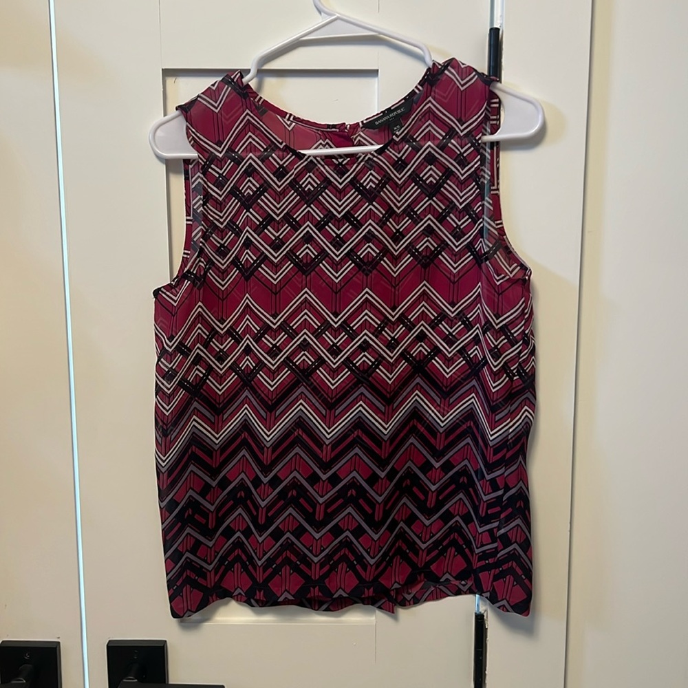 Women’s blouse. Sheer material. Button detail down the back.